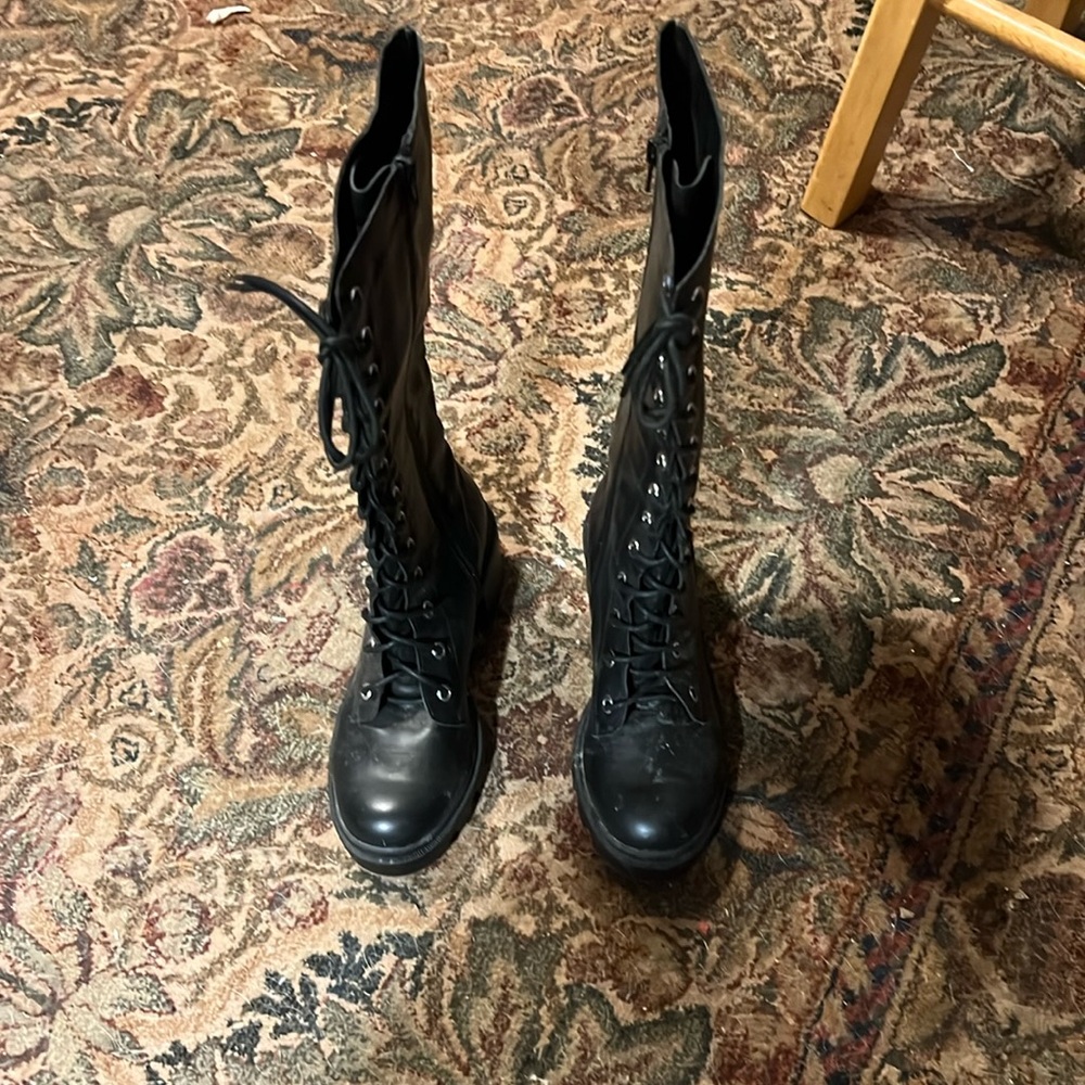 Black and they lace all the way up and zip on one side of the boots